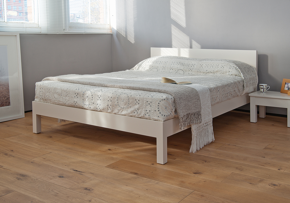 Sahara a contemporary low wooden bed here in a white lacquered finish