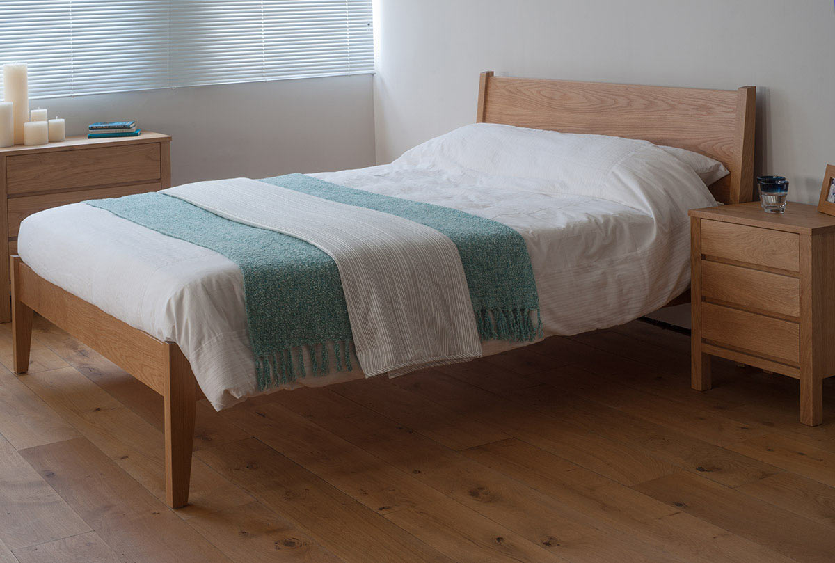 A taller classic wooden bed the Zanskar here made in Oak