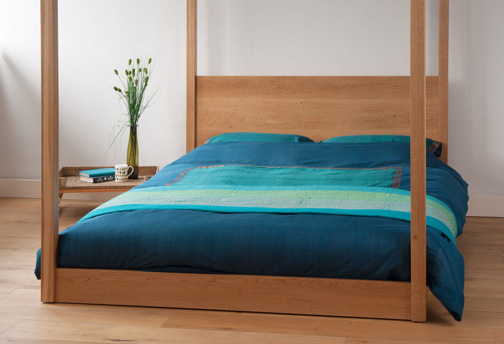 Cube - modern low four poster bed. To order in a range of sizes and wood options.