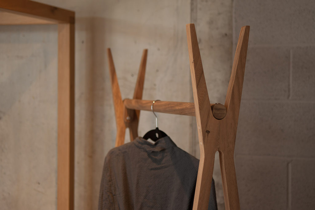 A closer view of the wooden clothes hanging rail