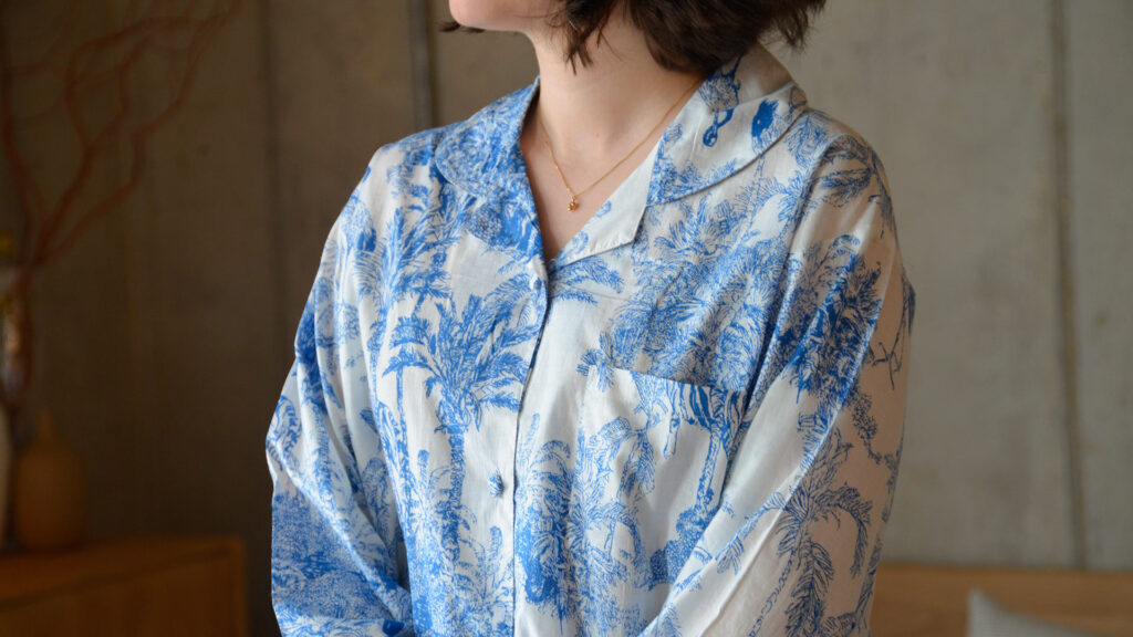 close up of jungle print PJ top in blue and white.