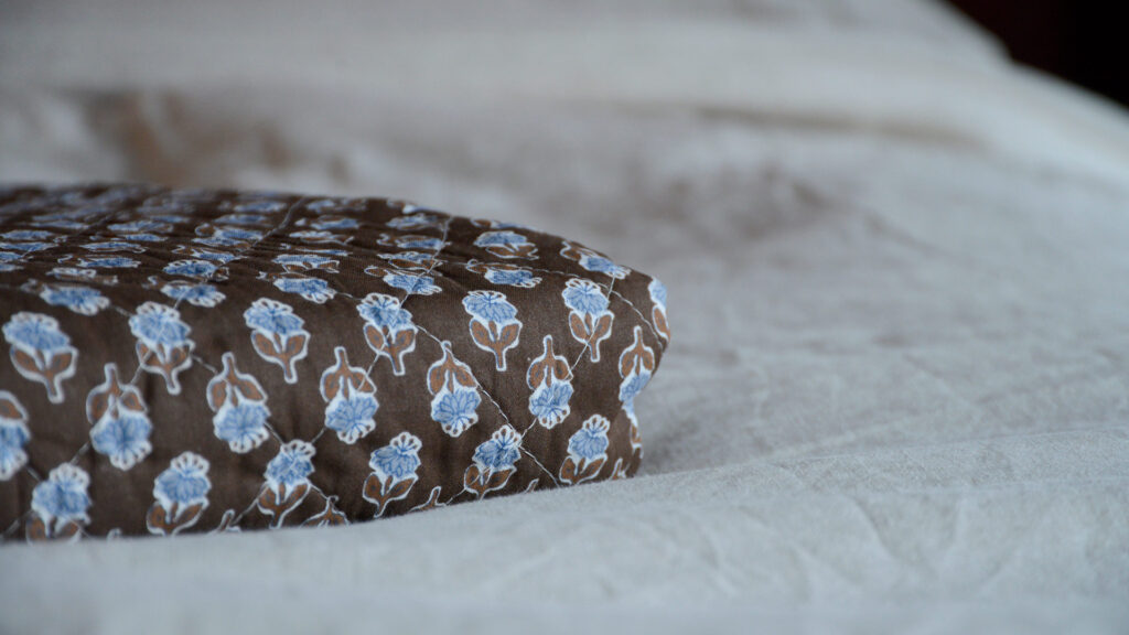 Brown Quilted Throw with Blue Flowers Folded