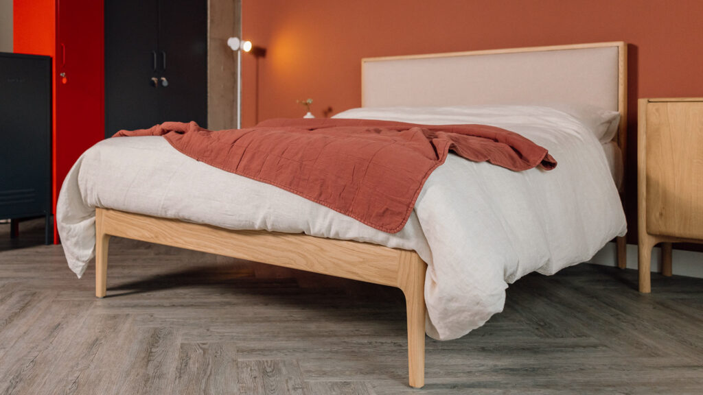 Carlisle bed in oak with an upholstered headboard panel in Amatheon