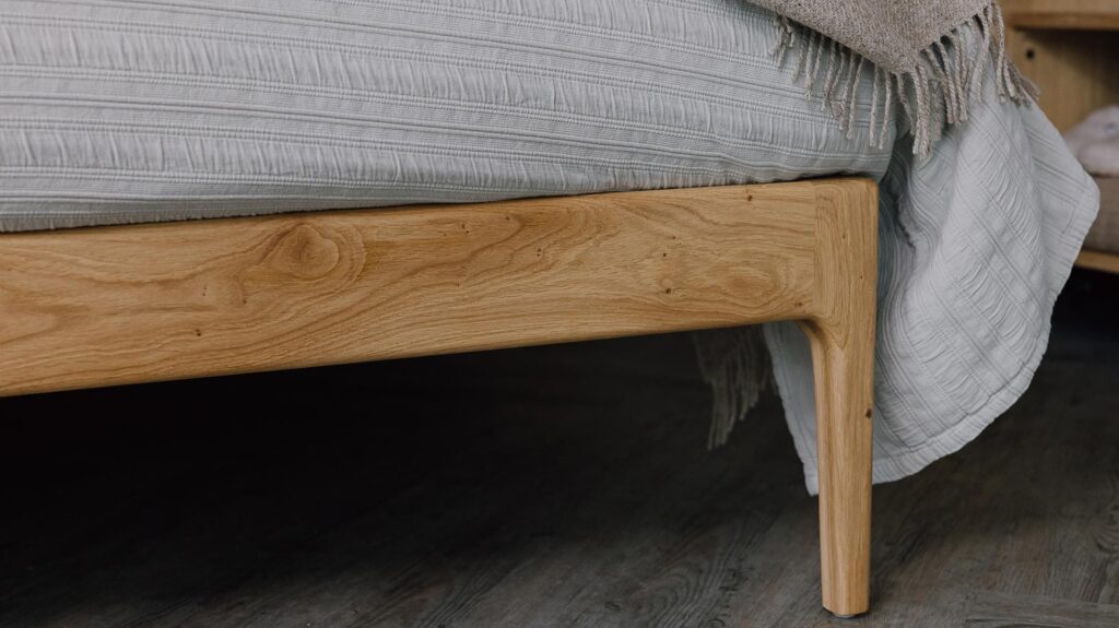 A close up shot of part of the English oak Chiswick's foot-rail/leg.