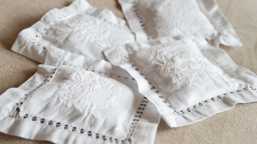 4 white embroidered lavender bags.