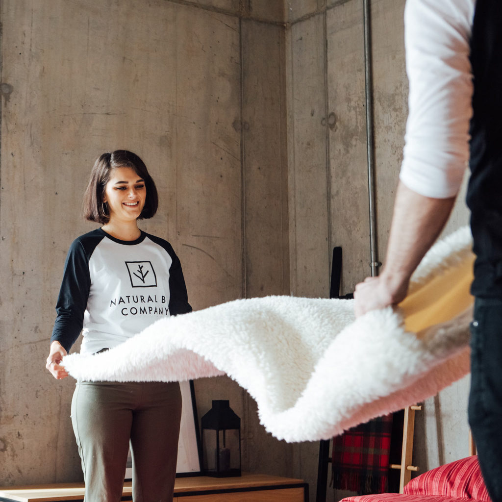 showroom staff dressing one of our wooden beds
