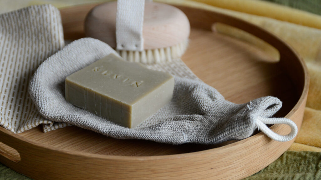 Meraki Exfoliating Glove on oak tray with Sevin soap
