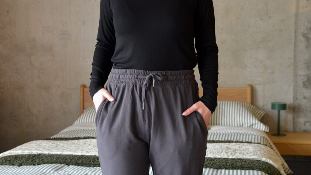 close up of waist line of charcoal lounge pants with tie detail.