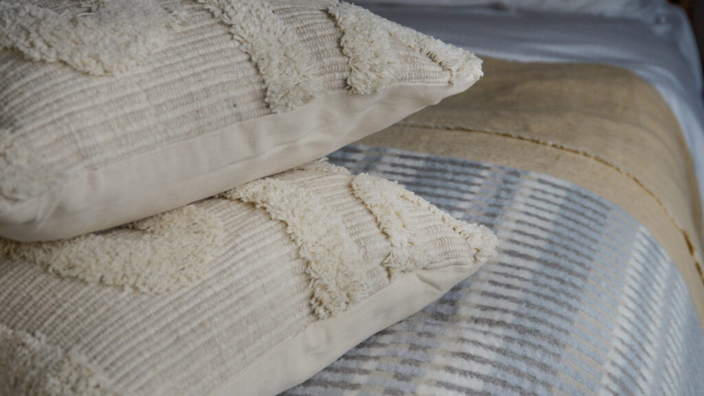 moroccan inspired tufted ecru coloured cushions shown close up