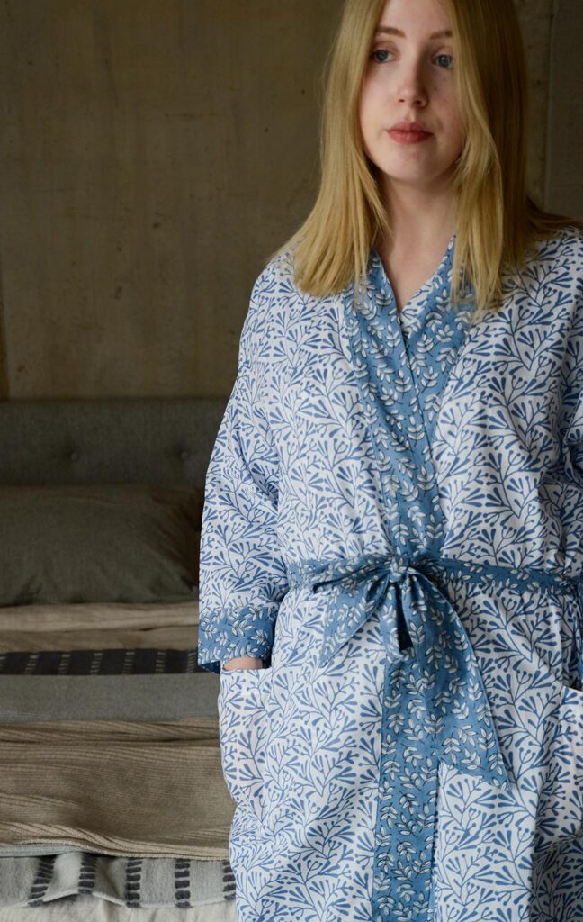 lightweight white cotton robe with a block print leaf design in blue and with contrast belt and cuffs