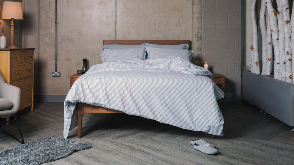 Blue and white striped cotton duvet cover and pillowcase set shown on a bed