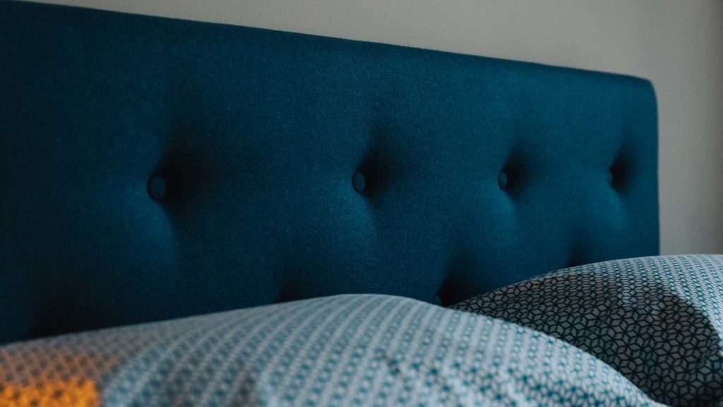 buttoned headboard on Arran teal