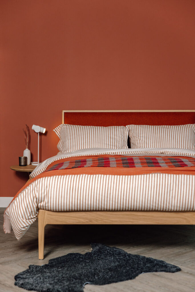 carlile bed with rust red bedding portrait