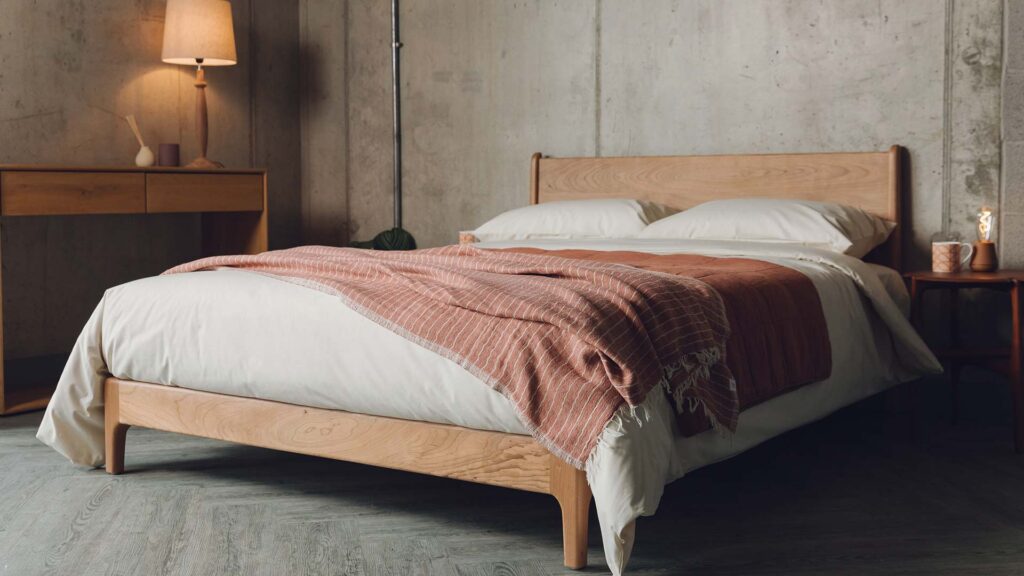 cherry Carnaby bed with cream and brick colour bedding
