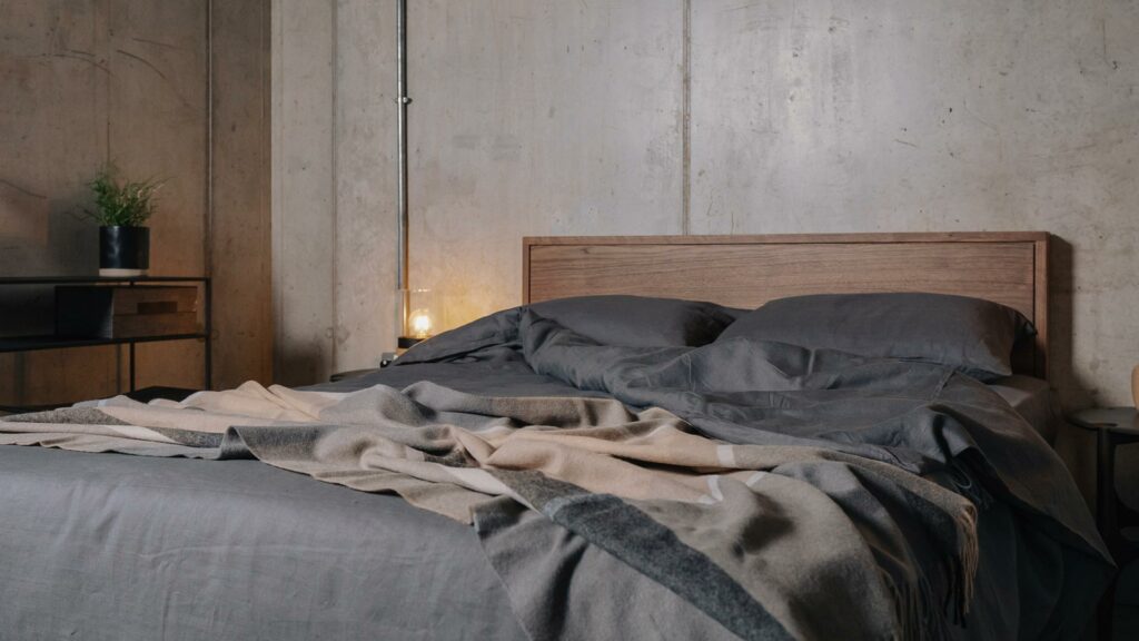 dark grey linen bedding with recycled alpaca throw