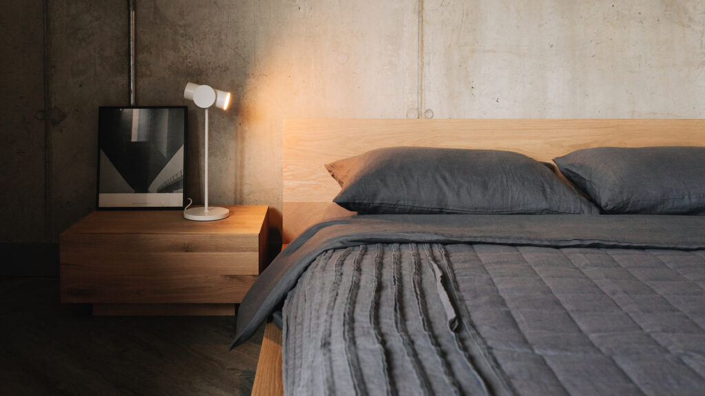 dark grey organic linen bedding on oregon bed with madra and stage lamp