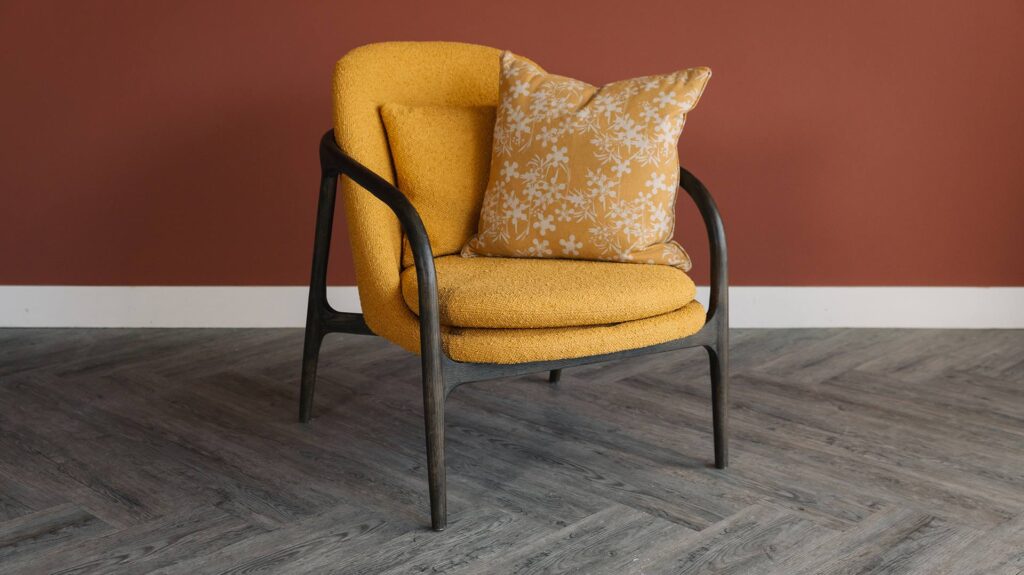 dark wood frame upholstered chair in mustard