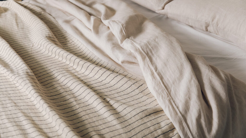 ecru linen bedding with light cotton throw in ivory