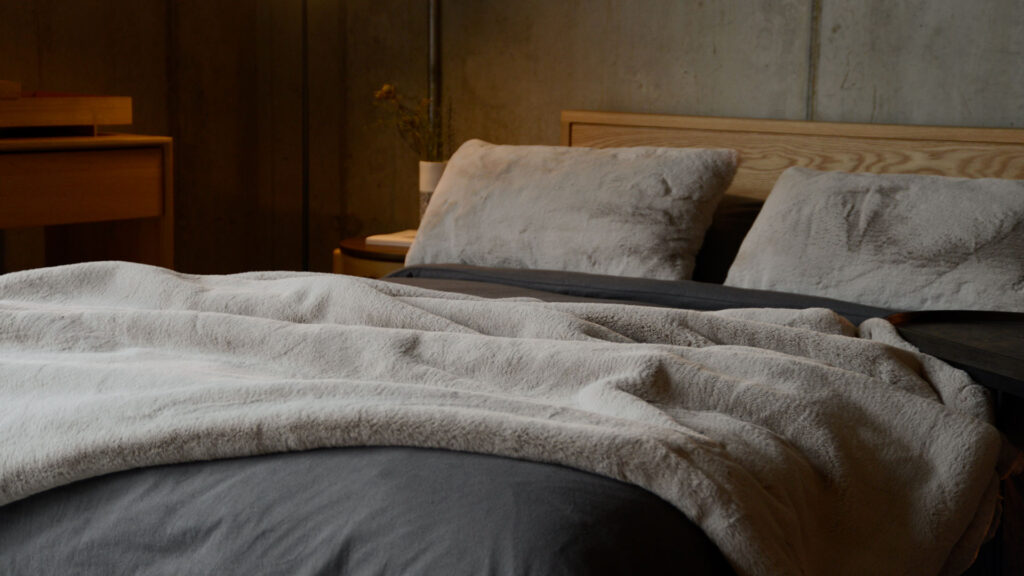 greige faux fur throw and cushions