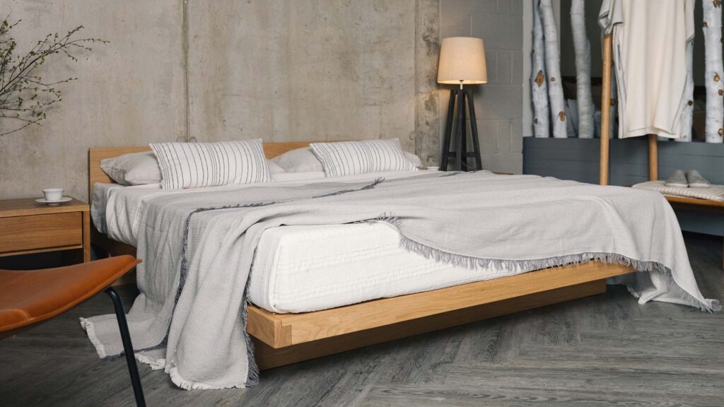 grey white bedding on low oak Kumo bed