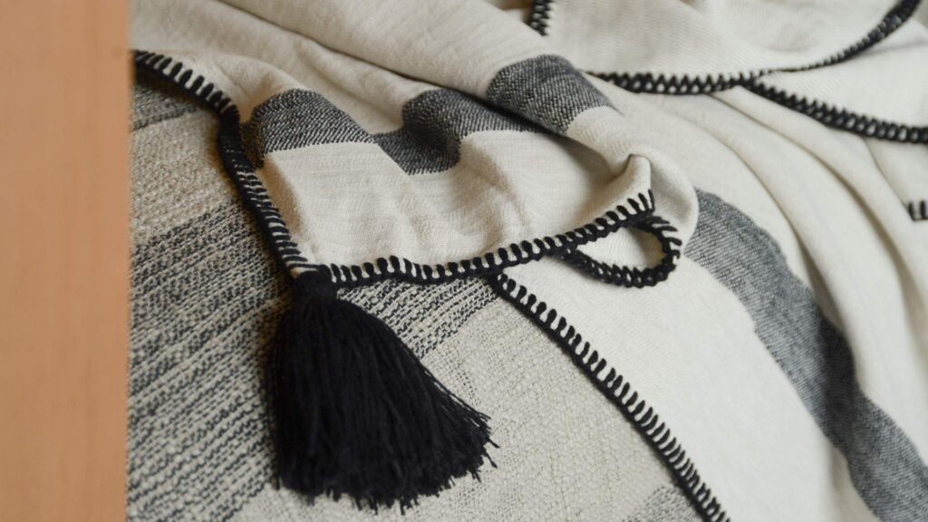 ivory and black throw with tassle detail