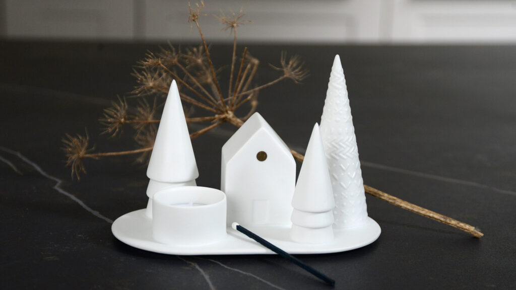 Snowy scene matt porcelain tea light holder with trees and a house