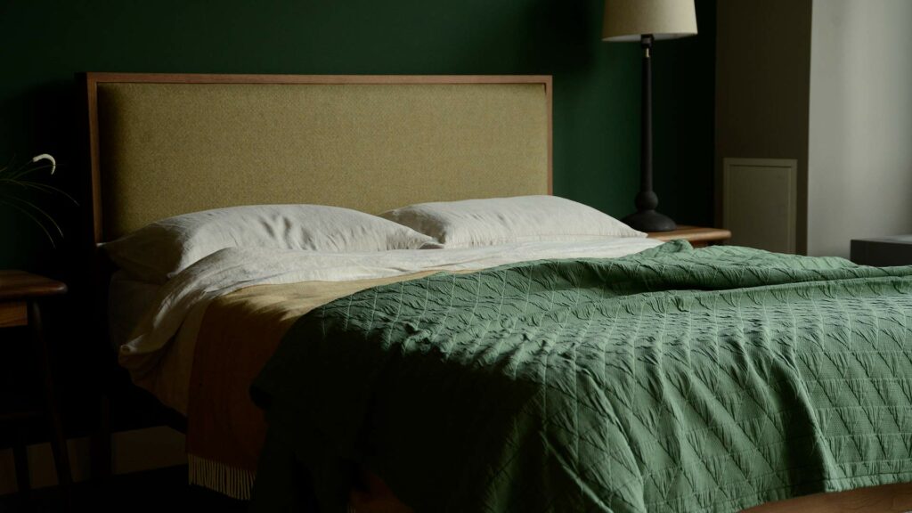 Textured patterned cotton bedspread in Jade green shown on a Kingsize Shetland bed