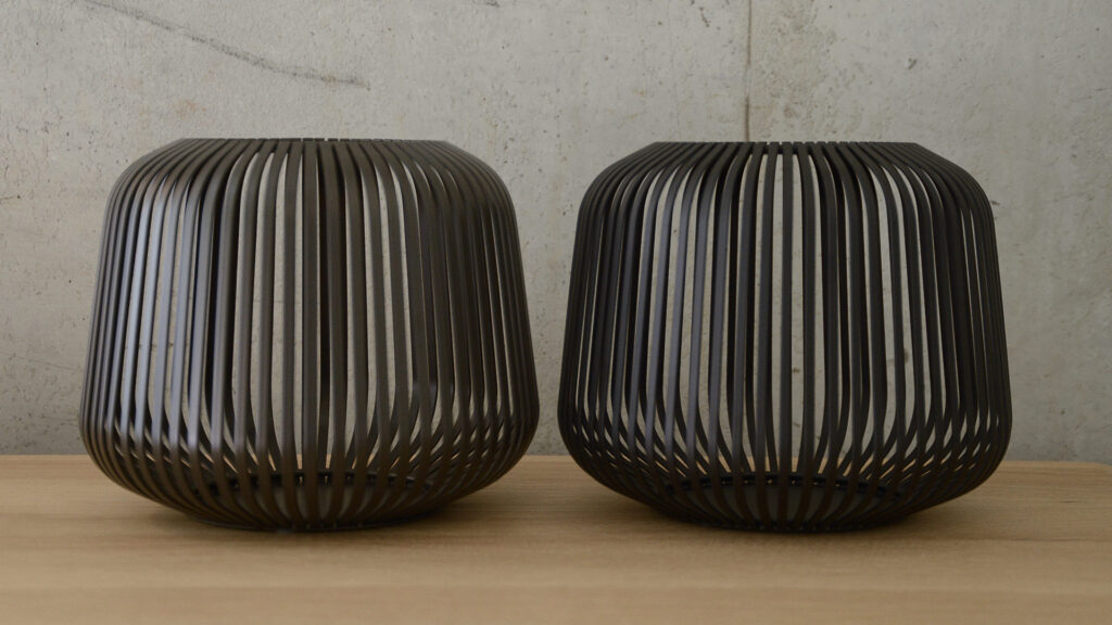 large metal lanterns, one bronzed one black.