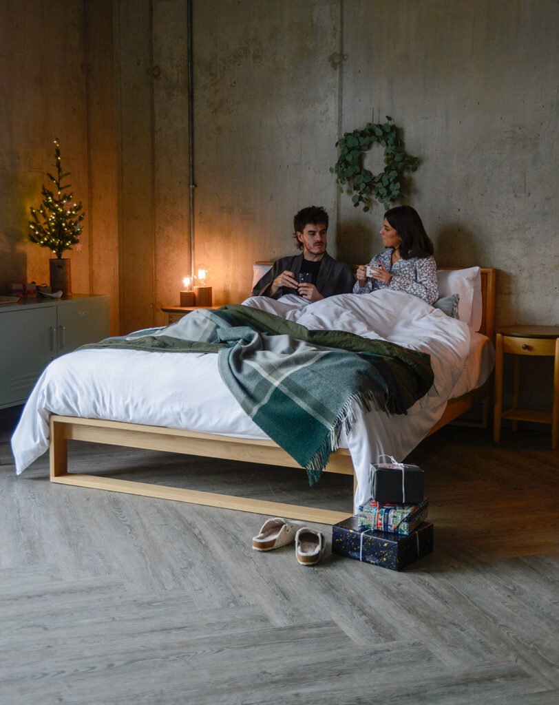 Christmas bedroom with couple in bed