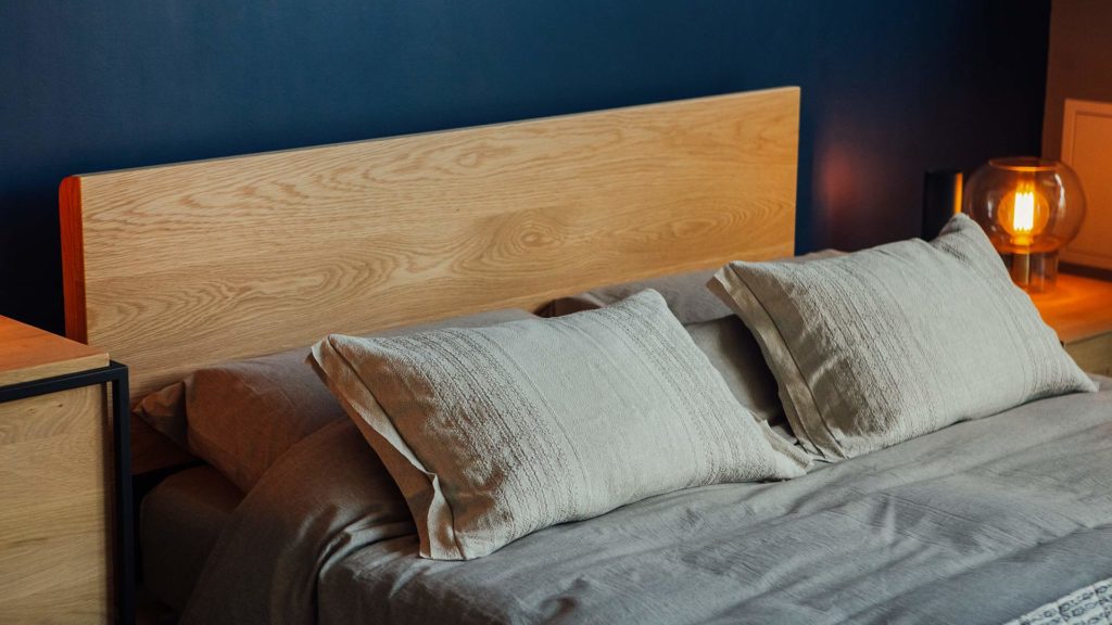 A closer view of the wooden Malabar bed headboard in Oak