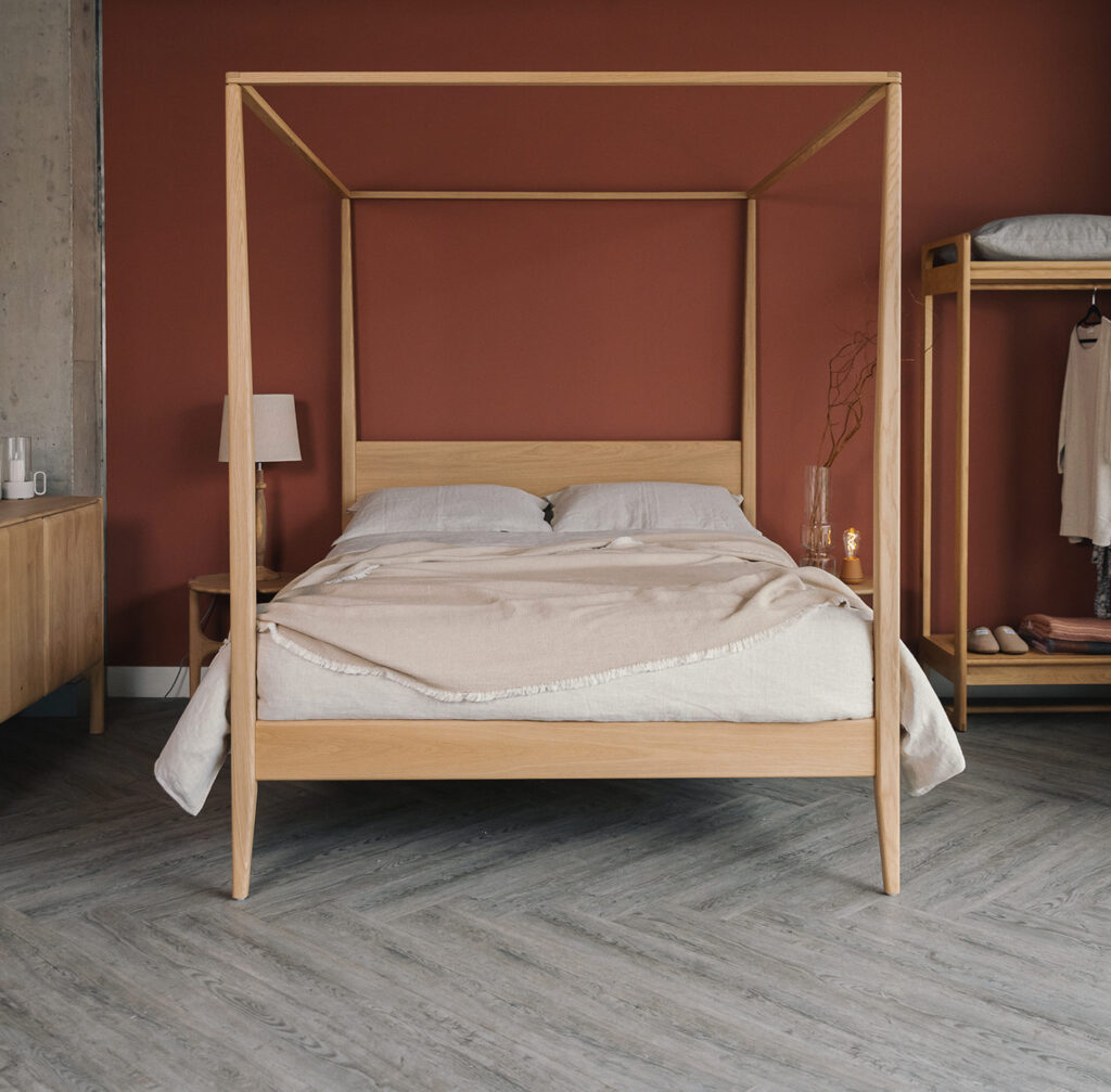 oak 4 poster Canterbury with linen bedding and textured throw portrait