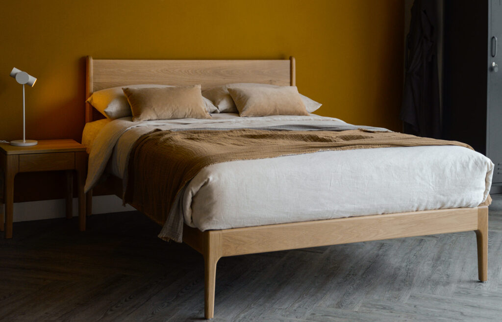 solid oak handmade camden bed with neutral bedding and grey lockers.