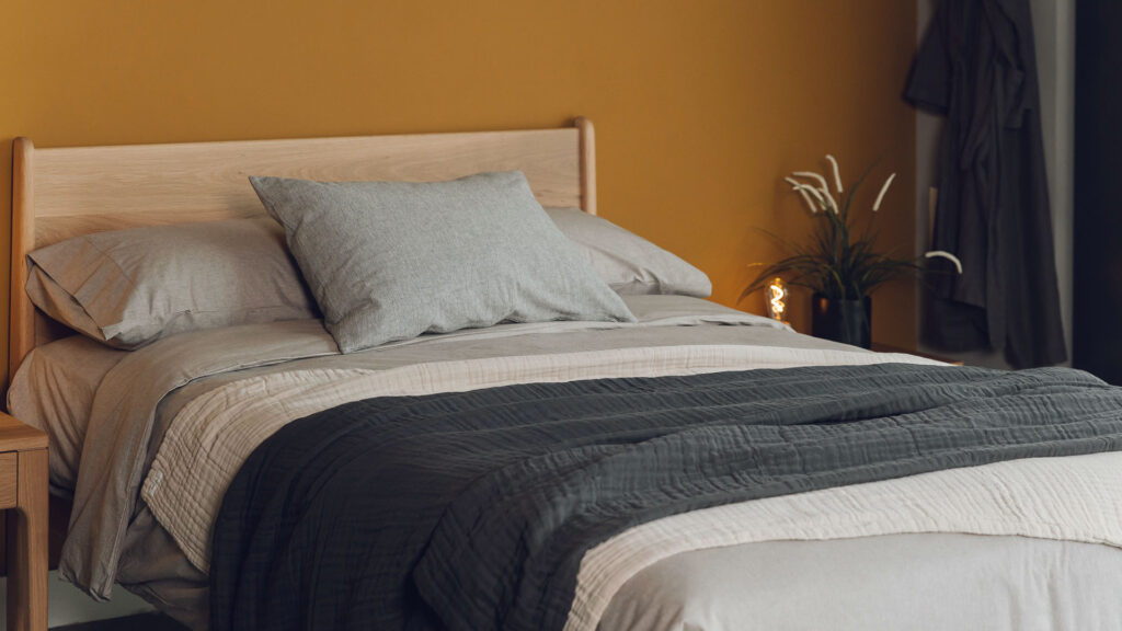 textured certified organic cotton blankets shown on a kingsize bed