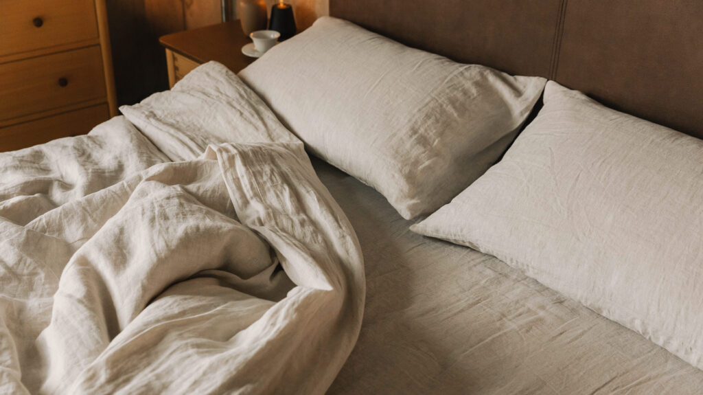 rumpled linen bedding in ecru