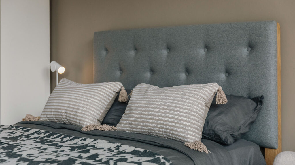 skye headboard in grey with taupe striped cushions
