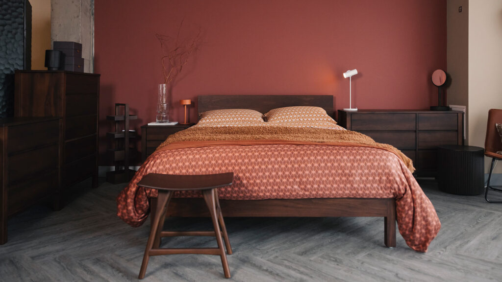 smoke walnut finish drawers and Malabr bed with rust printed bedding