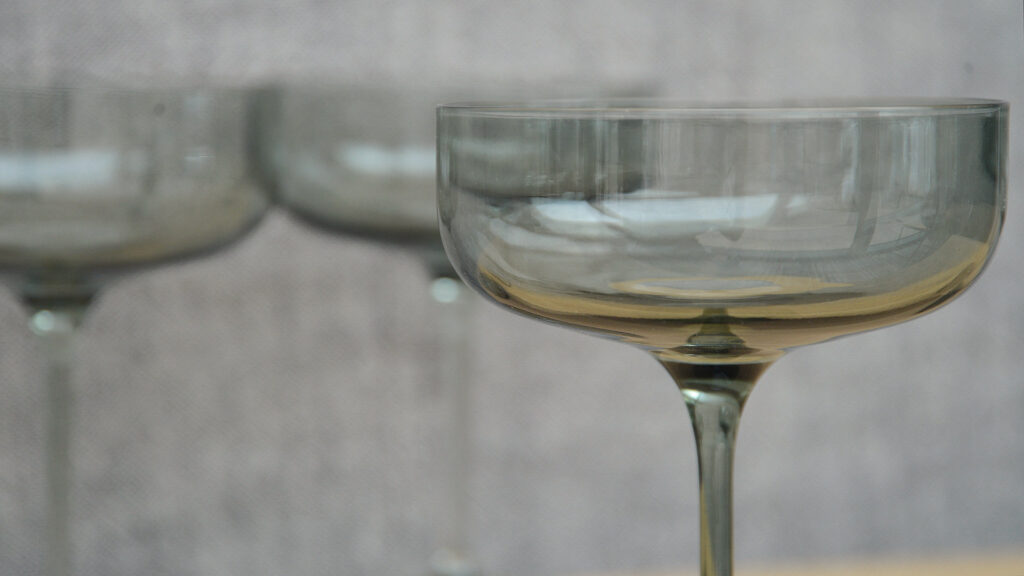 grey smoked glasse champagne saucer glass shown close up