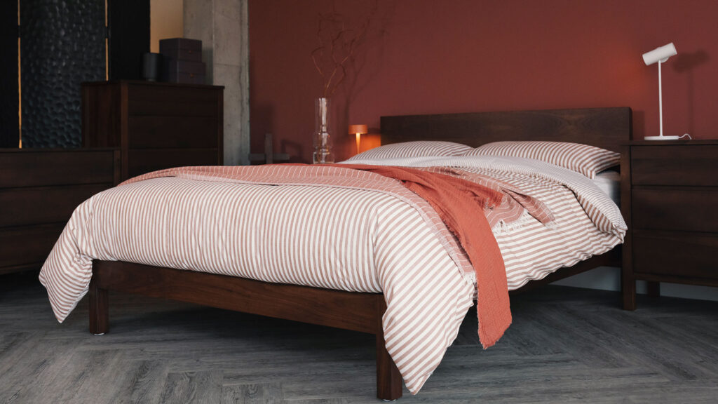 smoked walnut Malabar bed with striped cotton bedding brick