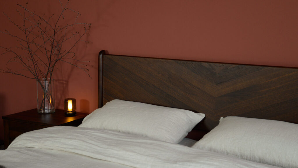 smoked walnut sale bed headboard corner detail with ecru linen and black lotus table