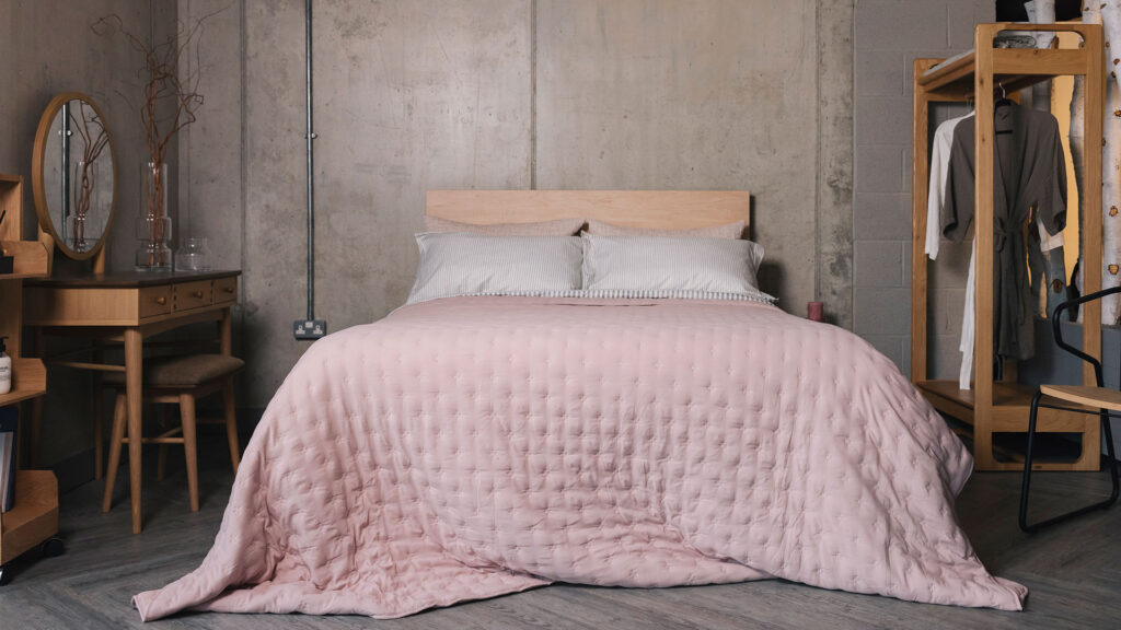 soft pale rose bedspread with cross embroidered detail