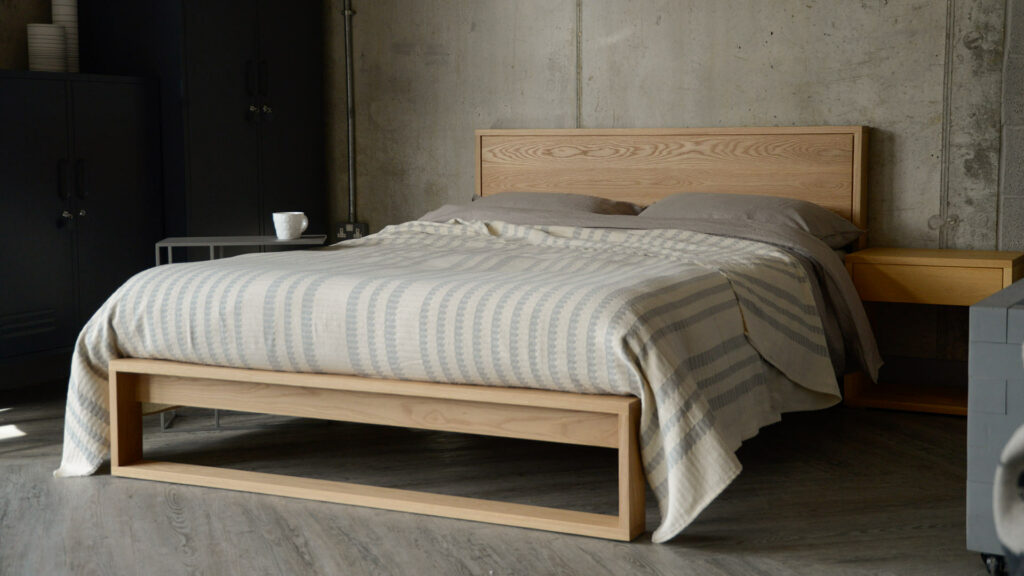 solid oak Leith bed with ivory and grey bedspread