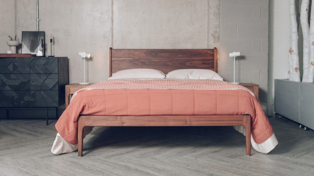 walnut Camden bed with terracotta bedding and black Ethnicraft chest.
