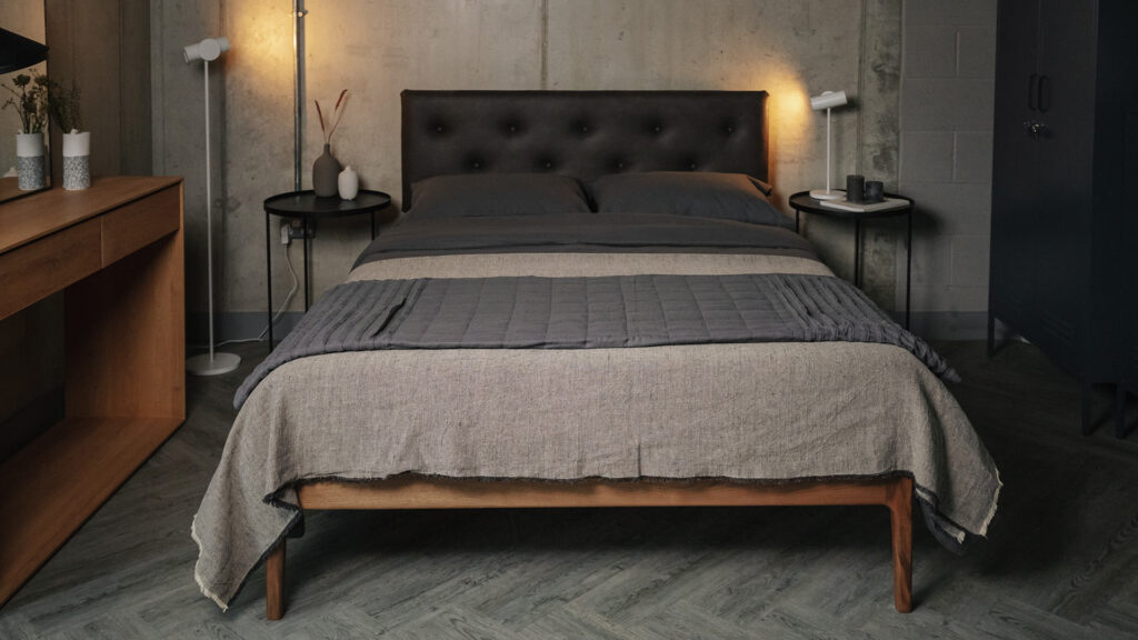 walnut bed with faux leather headboard brushed cotton bedding and linen throw