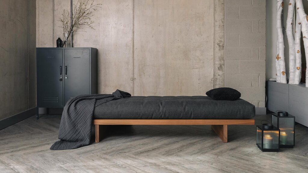 walnut daybed with dark grey mattress and organic cotton throw