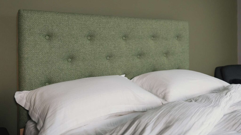 white muslin look bedding on skye with green headboard