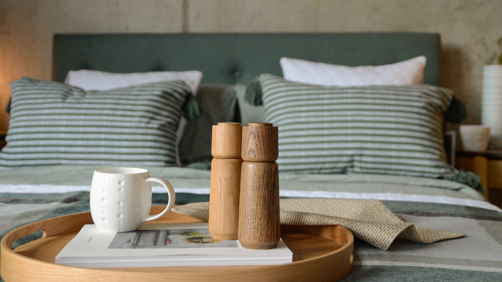 wooden salt and pepper grinder with mug on tray